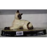 A Beswick seated Siamese cat, set on plinth base