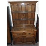 A 3' 6" polished oak two part dresser in the Georgian style with two shelf open plate rack over a