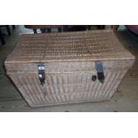 A 3' 3" vintage wicker laundry basket with iron latches and flanking handles