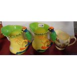 A pair of Burleigh Ware jugs with parrot pattern handles - sold with a Royal Winton printed jug