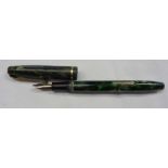 A vintage Conway Stewart 12 fountain pen with 14k nib in green marbled finish - lid cracked