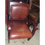 A late 20th Century Art Deco style stained wood show frame elbow chair, upholstered in brown leather