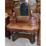 A 3' 11" Victorian mahogany duchess dressing table with arched swing mirror and four flanking