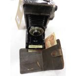 A Kodak Junior 1 bellows camera - sold with a wallet containing a Ten Shilling note