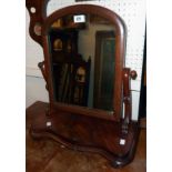 A Victorian figured mahogany platform dressing table mirror with arched plate and serpentine base