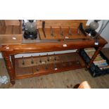 A 4' 5" modern stained wood hall table with brass lined bevelled glass inset top, turned supports