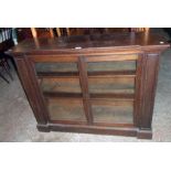 A 3' 11" 19th Century mahogany break front book cabinet with three shelves enclosed by a pair of