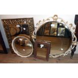 An embossed brass framed bevelled oblong wall mirror, vintage convex and pierced border bevelled