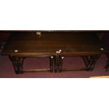 A polished oak coffee table with two nesting tea tables