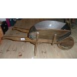 A 31" modern stained pine wheelbarrow pattern planter