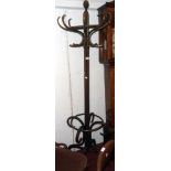 An early 20th Century stained bentwood free-standing hat and coat stand with finial to top and