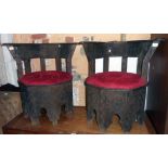 A pair of late 20th Century Moroccan carved and stained wood framed elbow chairs in the Moorish