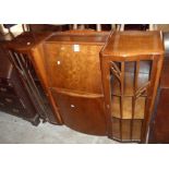 A 4' mid 20th Century polished walnut side-by-side cabinet with central fall and cupboard flanked by