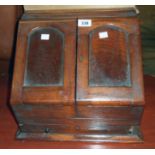 A 14 1/4" Victorian mahogany slope fronted stationery box with fold-out doors enclosing a part