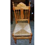 A pair of pine framed kitchen chairs with turned spindles, splat backs and woven rush seats