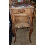 A late 19th Century French walnut and quarter veneered ornate pot cupboard with moulded marble inset