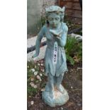 A painted cast iron garden fairy standing and holding a shell