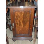 A 16" Edwardian quarter sawn oak pot cupboard with figured walnut veneered panel door, set on turned