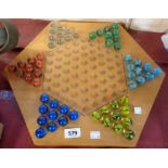 A large Chinese Checkers board and part set of marbles - one marble missing