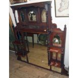 A 4' 3" Edwardian walnut ornate overmantel mirror with multi arcaded and oblong plates, an array