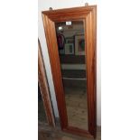 A modern waxed pine framed narrow oblong wall mirror