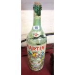 An oversized Martini bottle
