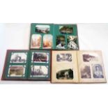 Three antique postcard albums containing a collection of mainly early 20th Century postcards