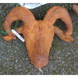 A cast iron garden ram's head with rusted finish