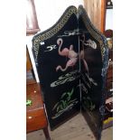 A vintage four fold dressing screen with stencilled flamingo decoration on studded black rexine