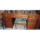 A 4' 8" modern Oriental hardwood twin pedestal desk with bracketed top, three frieze drawers and