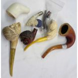 A collection of pipes including gourd calabash (bowl missing), meerschaum heads, clay bowl, etc.