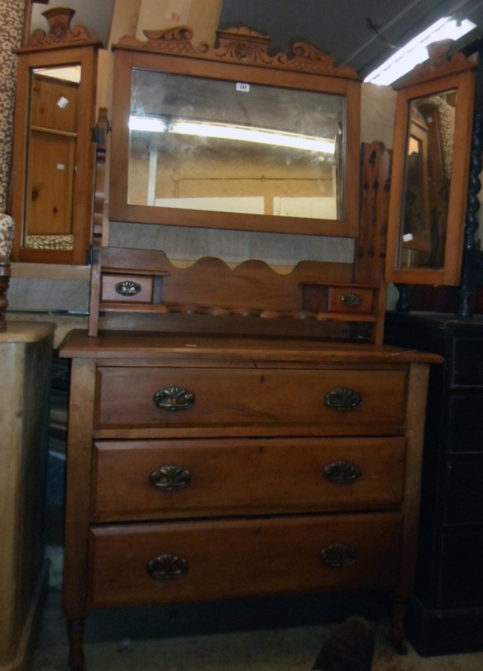 A 36" Edwardian walnut dressing chest with triple mirror, flanking pierced supports, trinket drawers