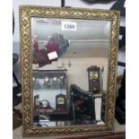 An easel mirror with pressed brass frame