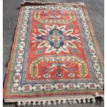 An Indian Elmaz rug of typical design with central medallion on red ground - 6' 4" X 4' 10" (193cm X