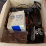 A box containing a Kodak 35 camera and various photographic equipment