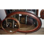 An early 20th Century polished wood and beaded framed bevelled oval wall mirror - sold with another