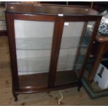 A 35 1/2" retro Swedish stained mixed wood display cabinet with glass shelves enclosed by a pair