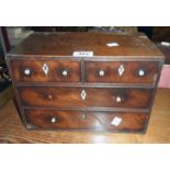A 12" early 19th Century mahogany miniature chest of two short and two long graduated drawers - a/f