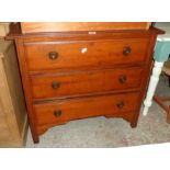 A 36" Edwardian walnut chest of three long drawers, set on bracketed and moulded supports