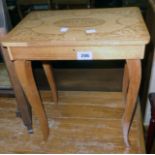 A souvenir musical work table with decorative lift-top and slender cabriole legs