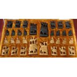 A cased Indian carved wood elephant and howdah chess set