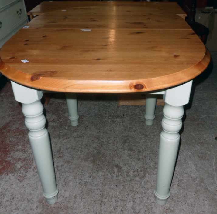 A 20th Century waxed pine top D-end draw-frame extending dining table with stowed folding leaf,