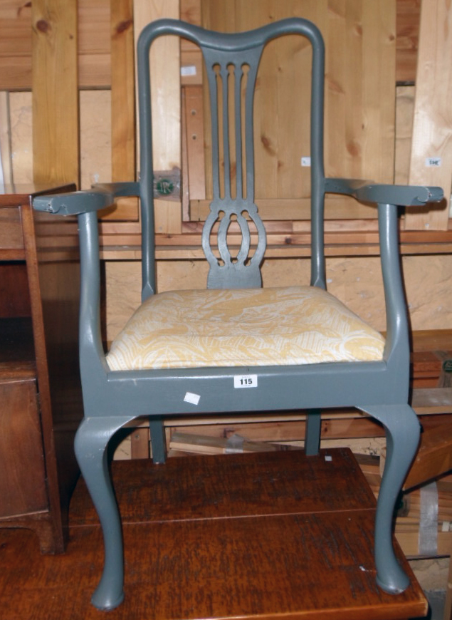 A painted wood framed elbow chair with pierced splat back and upholstered drop-in seat, set on