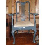 A painted wood framed elbow chair with pierced splat back and upholstered drop-in seat, set on