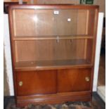 A 30" vintage stained mixed wood book cabinet with sliding doors to top and further sliding doors