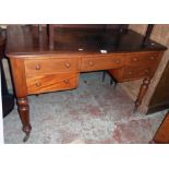 A 4' Victorian mahogany knee-hole dressing table with central frieze drawer and four flanking