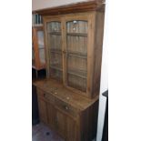 A 3' 6" old waxed pine two part dresser with plate shelves enclosed by a pair of glazed panel