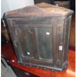 A 23" Victorian stained oak wall hanging corner cupboard with pierced decoration to top and