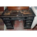 A 3' 6" Victorian ebonised and carved oak knee-hole desk with remains of writing surface, three