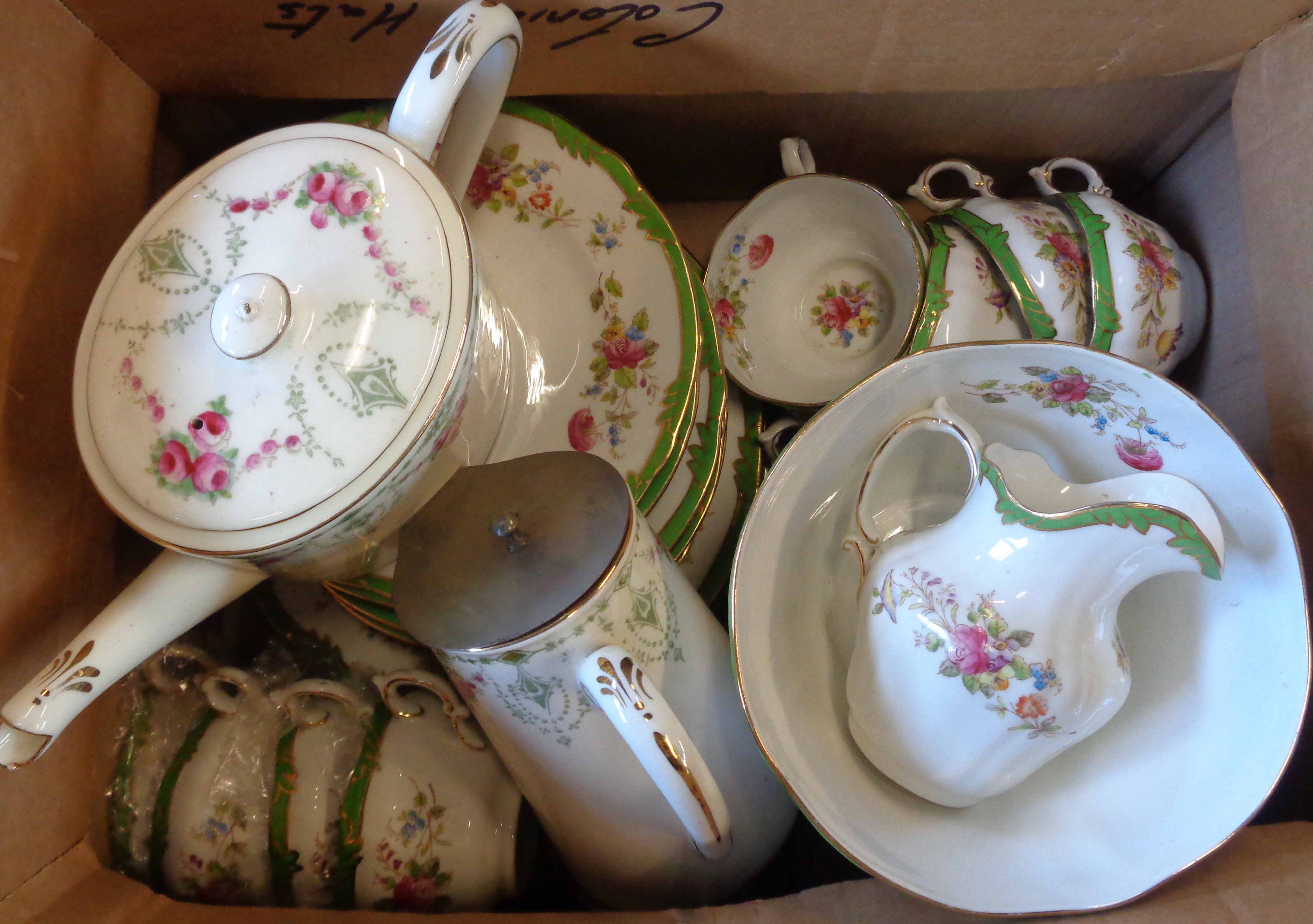 A floral decorated tea set, retailed by Harrods - sold with a teapot and hot water jug